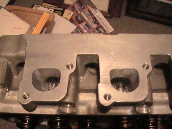 Close-up of an aluminum engine cylinder head with intake ports visible