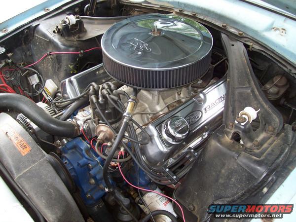 Close-up of a Ford V8 engine with chrome valve covers that say "Ford Racing"