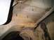 1996 Ford Bronco - The underside of a vehicle shows a rusty frame with newly installed bolts, possibly for a cage build.
