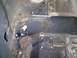 1996 Ford Bronco - Metal plates are bolted to the rusted interior floor of a vehicle, likely for a roll cage.