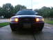 2003 Ford Crown Victoria - 2003 Ford Crown Victoria police car, front view, with emergency light bar illuminated.