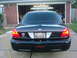 2003 Ford Crown Victoria - Rear view of a black 2003 Ford Crown Victoria, equipped with a light bar and displaying a Texas license plate.