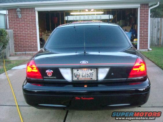 Rear view of black 2003 Ford Crown Victoria Police Interceptor with light bar
