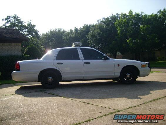 White 2003 Ford Crown Victoria police car, side view