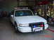 2003 Ford Crown Victoria - This police car appears to be a 1990s model, not a 2003 Ford Crown Victoria.