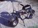 1970 Honda Trail - A blue mini bike with a black seat sits on a dirt path covered in snow.
