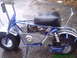1970 Honda Trail - Side view of a blue mini bike with a small engine and chrome accents.