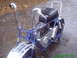 1970 Honda Trail - A blue mini bike with chrome accents sits on a wet asphalt surface.