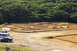 1986 Ford Bronco - An outdoor RC car track is set up with a white van and a dark sedan parked to the side.