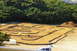 1986 Ford Bronco - An outdoor RC car track is set up with dirt and barriers, ready for racing.