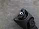 1978 Ford Bronco - A close-up view of a vehicle's driveshaft U-joint is shown against a concrete surface.