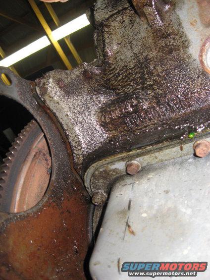 Oil pan gasket behind starter motor location. Pushed all the way out. Thank you Ford Motor Company.....