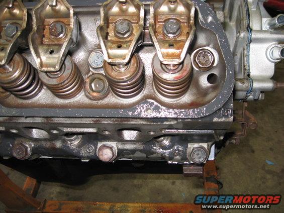 Close-up of an engine cylinder head with rocker arms and valve springs visible