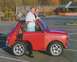 1991 Ford Bronco - A woman poses with a bright red Mini Cooper in a parking lot.