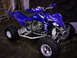 2004 Yamaha YFZ450 - A blue Yamaha YFZ450 ATV is parked indoors with a ladder in the background.