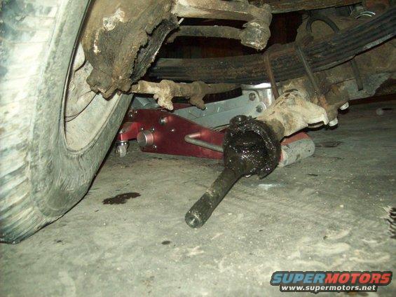 Front suspension assembly with a jack under the vehicle. 1971 Ford F-100