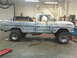 1971 Ford F-100 - Side view of a 1971 Ford F-100 pickup truck undergoing modifications in a garage setting.