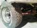 1971 Ford F-100 - Detail shot of truck suspension components, including a tire, wheel, and shock absorber.