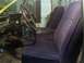 1971 Ford F-100 - The interior of a truck shows a steering wheel, gear shift, and two rows of purple seats.