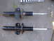 1992 Ford Taurus - Comparison of a used suspension strut with a newly painted strut, likely for replacement.