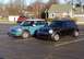 2003 Ford Crown Victoria - Two Mini Coopers are parked side-by-side in an outdoor lot.