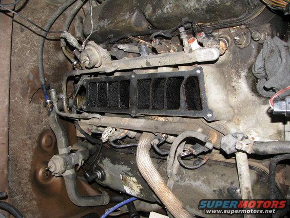 fuel, electrical, and vacuum lines removed.  all bolts loose.  time to yank it.