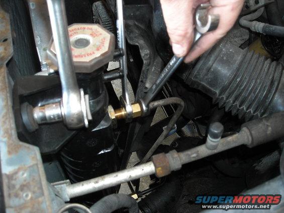 picture-014.jpg a 1/2 inch line wrench and a 5/8 open end is used to take off the transmission lines.
USE A LINE WRENCH.
trying to cheap out here will probably round off the radiator nut.
Hold the larger nut with the 5/8 and loosen the 1/2 inch one so it spins.
Then, loosen up the 5/8 all the way out of the radiator. Keep an eye on the line and make sure that 1/2 is spinning with the 5/8 so you don't kink the line.
