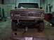 1971 Ford F-100 - This Ford truck is in a garage, possibly undergoing repairs, with a jack supporting the front end.