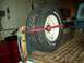 1971 Ford F-100 - Spare tire mounted in the bed of a pickup truck, secured with a red strap.