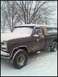 1996 Ford Bronco - Pickup truck with camper shell parked in a snowy field during winter. Supermotors.net logo is present.