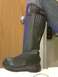 1995 Ford Probe - Black motorcycle boot on a person's leg, standing next to a wooden door.