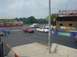 1999 Ford Taurus - A white sedan with racing stripes drives on a track at Norwalk Raceway Park.