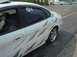 1999 Ford Taurus - This sedan features a custom tribal graphic design along its side panels and shiny chrome wheels.