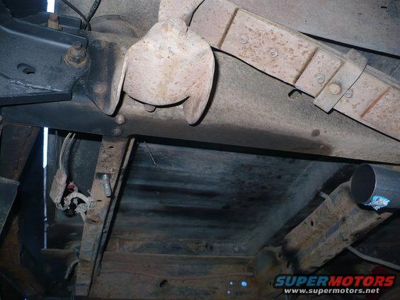 Undercarriage with leaf springs, exhaust pipe, and wiring harness