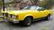 1973 Mercury Cougar - This yellow 1973 Mercury Cougar convertible features a black stripe along the lower body and hood accents.