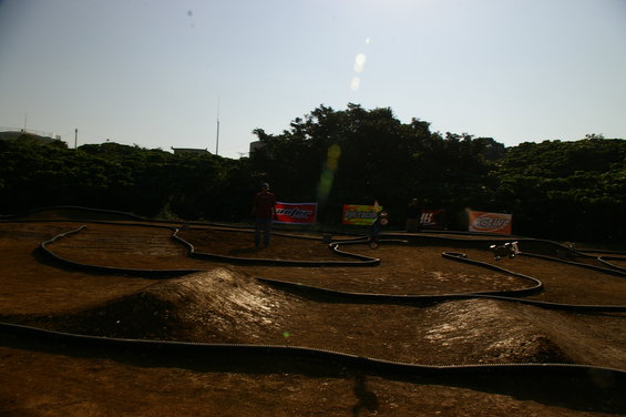 Remote control car track with jumps and banners in the background