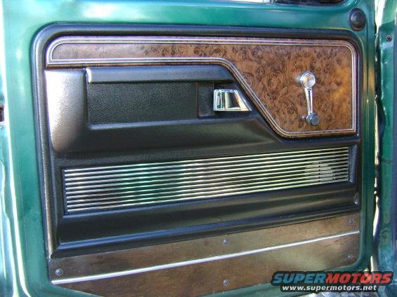 Green truck interior door panel with wood grain trim and chrome accents