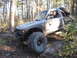 1984 Ford Bronco II - Modified 1984 Ford Bronco II navigating a rocky trail in a forest setting.