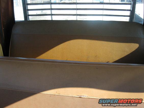 Brown truck interior with slatted rear window and bench seat