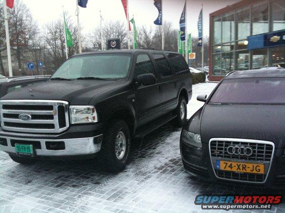 Black Ford Excursion parked next to an Audi. The Excursion has a Dutch license plate