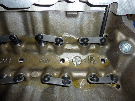 Ford engine block showing rocker arms and casting marks including 'P23', 'Ford' oval logo, and a date code