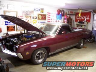 Maroon 1970 Ford Ranchero with hood open, showing engine, in a garage