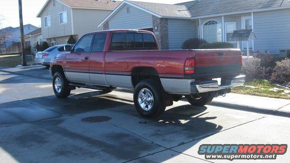 1997 Dodge 2500 pickup truck, red and silver two-tone paint, parked in driveway