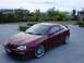 1993 Mazda MX-3 - A maroon 1993 Mazda MX-3 is parked in front of a house with a landscaped yard.