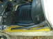 1983 Volkswagen Rabbit - Interior view of a car showing a black seat and a metal roll cage bar installed near the floor.