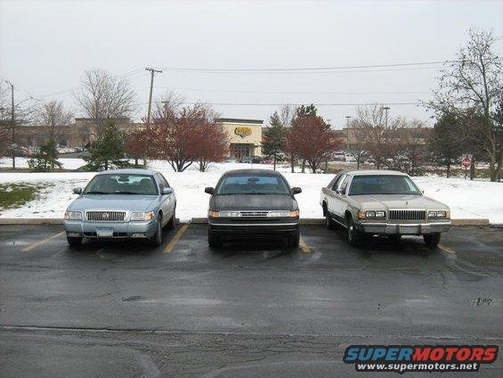 1988 Mercury Grand Marquis parked next to two other sedans in a snowy parking lot