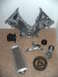 1992 Ford Bronco - Various engine components including a timing cover and oil cooler are displayed on a carpeted surface.