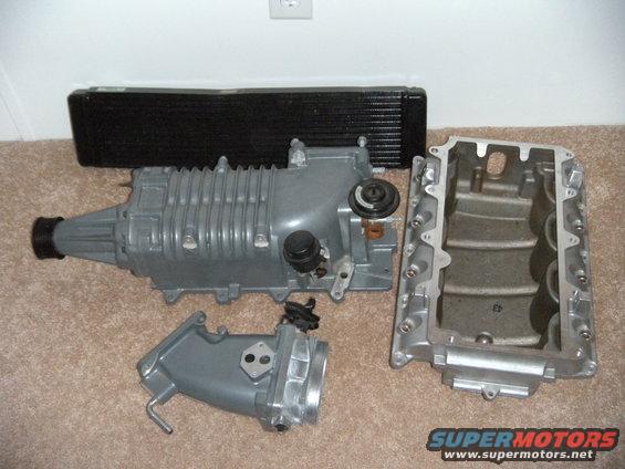 Supercharger, intercooler, and intake manifold laid out on carpet