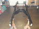1997 Ford Ranger - Vehicle frame assembly on jack stands, likely undergoing restoration or repair.