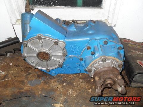 Blue transfer case with metal plate on the side. Text is visible on the casing